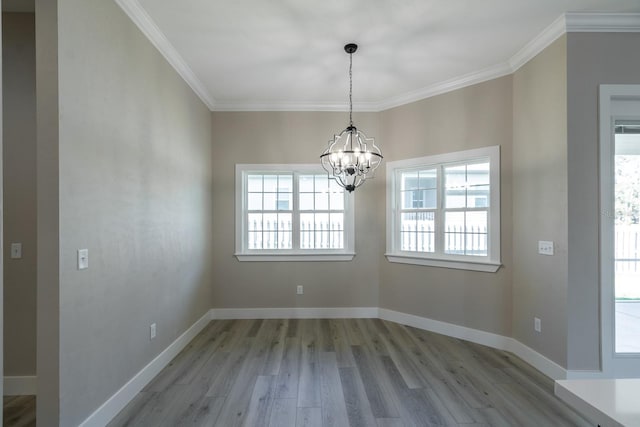 11828 NW 15th Rd, Gainesville, FL 32606 - unfurnished dining area with a notable chandelier, baseboards, ornamental molding, and wood finished floors