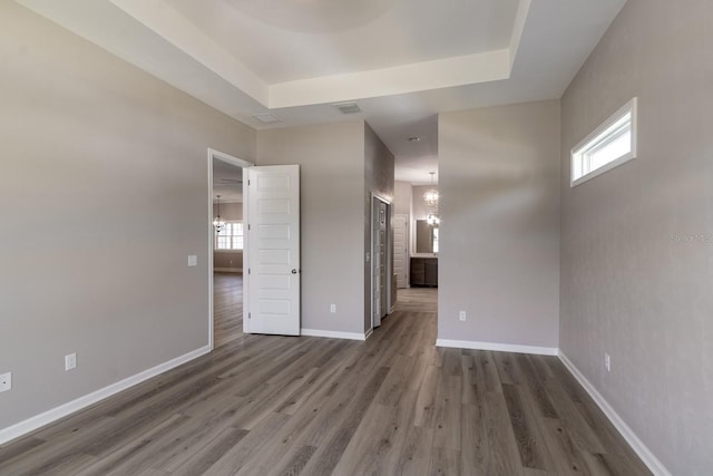 11828 NW 15th Rd, Gainesville, FL 32606 - empty room with visible vents, dark wood-style flooring, baseboards, and a raised ceiling