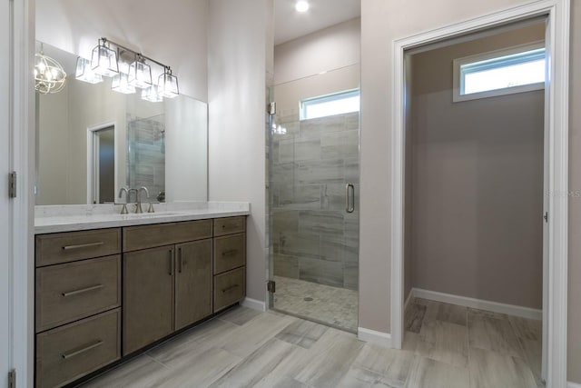 11828 NW 15th Rd, Gainesville, FL 32606 - bathroom featuring baseboards, a stall shower, and vanity