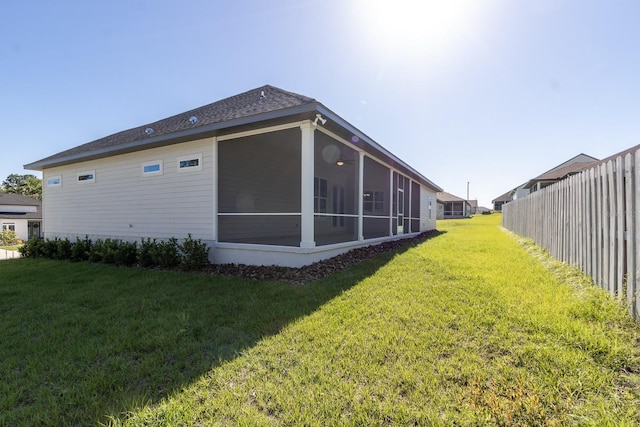 11828 NW 15th Rd, Gainesville, FL 32606 - back of property featuring a yard, fence, and a sunroom