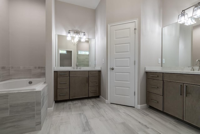 11828 NW 15th Rd, Gainesville, FL 32606 - full bath with a sink, two vanities, baseboards, and a garden tub