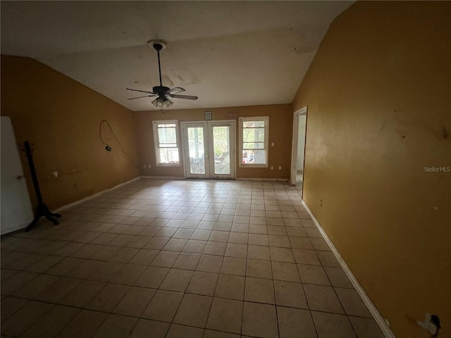 unfurnished room with ceiling fan, light tile patterned floors, and lofted ceiling