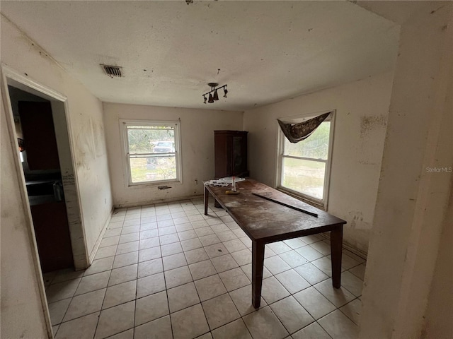 unfurnished dining area with light tile patterned flooring