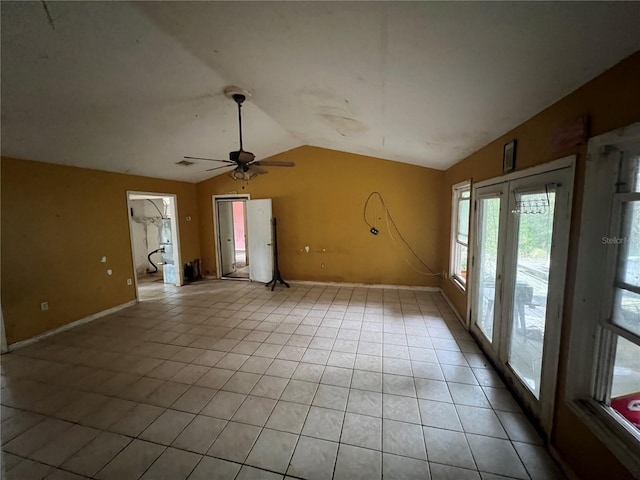 interior space with lofted ceiling and light tile patterned floors