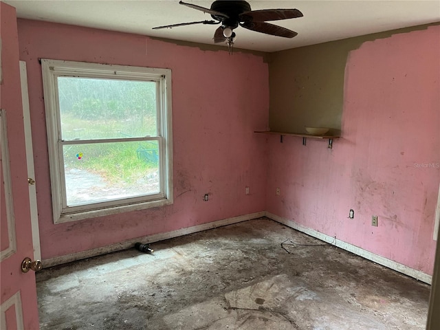 empty room with ceiling fan and a wealth of natural light