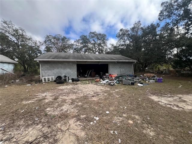 rear view of property featuring an outdoor structure