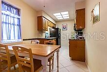 kitchen featuring kitchen peninsula and light tile patterned flooring