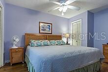 bedroom with ceiling fan and dark hardwood / wood-style floors