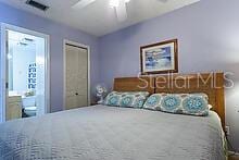 unfurnished bedroom featuring ensuite bathroom and ceiling fan