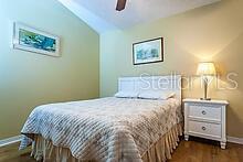 bedroom featuring wood-type flooring, ceiling fan, and lofted ceiling