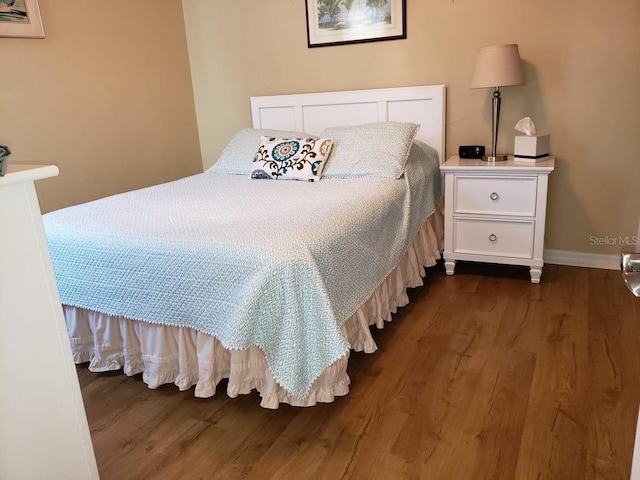 bedroom featuring dark wood-type flooring