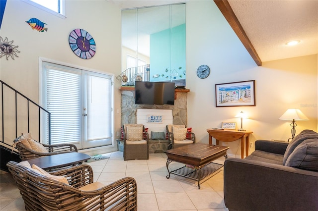 living room featuring a textured ceiling, a towering ceiling, and light tile patterned flooring