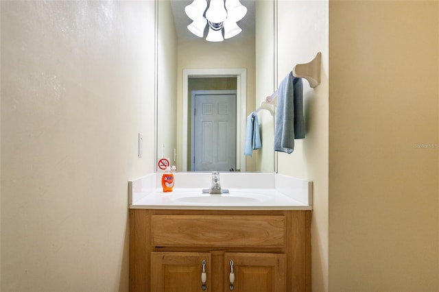 bathroom with vanity and a notable chandelier