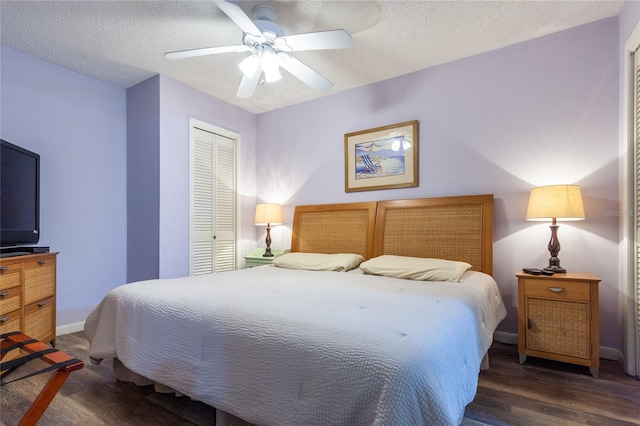 bedroom featuring a textured ceiling, ceiling fan, a closet, and dark hardwood / wood-style floors