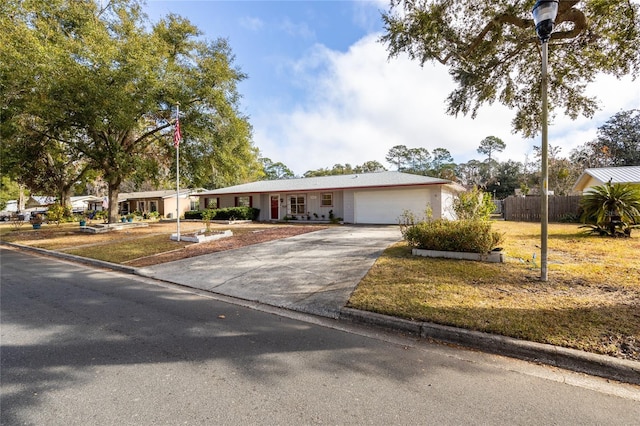 single story home featuring a front yard and a garage