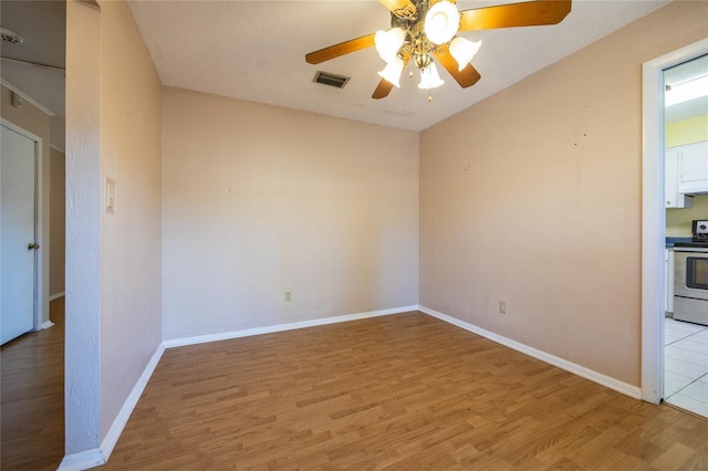 unfurnished room with ceiling fan and hardwood / wood-style flooring