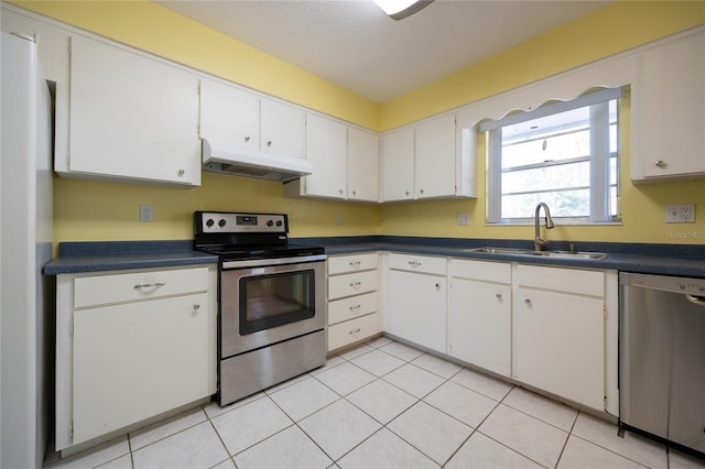 kitchen featuring light tile patterned floors, white cabinetry, sink, and appliances with stainless steel finishes