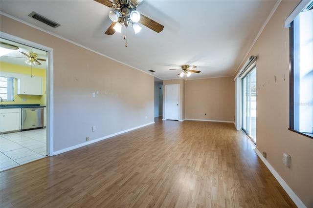 spare room featuring sink, light hardwood / wood-style flooring, and ornamental molding