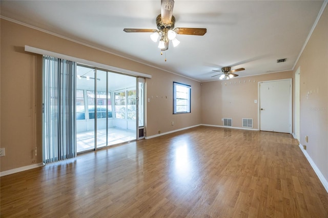 spare room with ceiling fan, crown molding, and light hardwood / wood-style floors