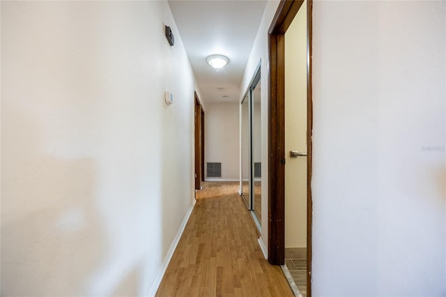 corridor featuring light hardwood / wood-style floors