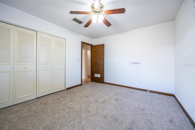 unfurnished bedroom featuring ceiling fan, light carpet, and a closet