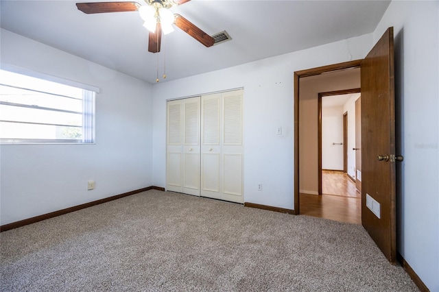 unfurnished bedroom with ceiling fan, carpet floors, and a closet