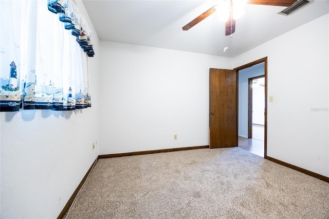 carpeted spare room with ceiling fan