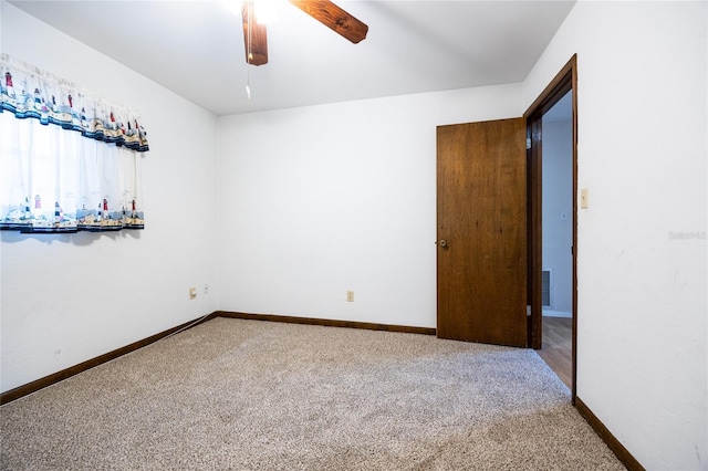 spare room featuring carpet floors and ceiling fan