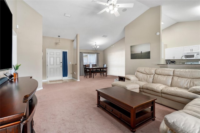 living room featuring light carpet, sink, high vaulted ceiling, and ceiling fan with notable chandelier