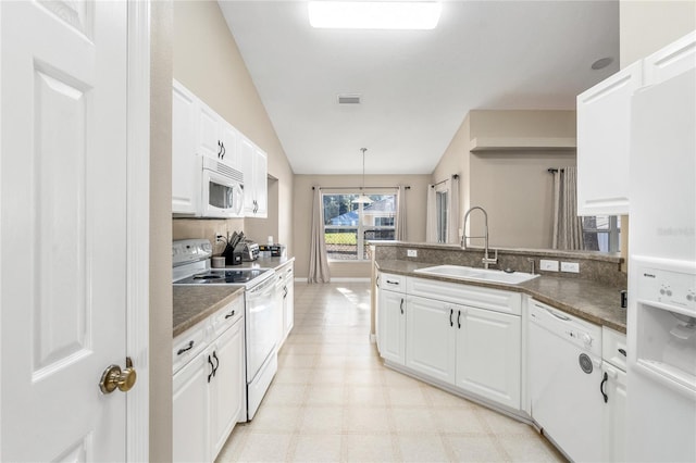 kitchen featuring white appliances, white cabinetry, hanging light fixtures, and sink