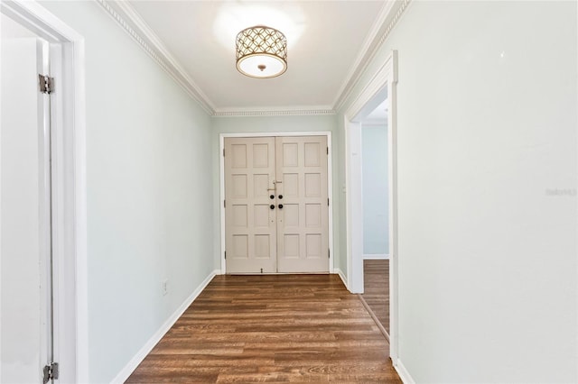 foyer with dark hardwood / wood-style floors and crown molding