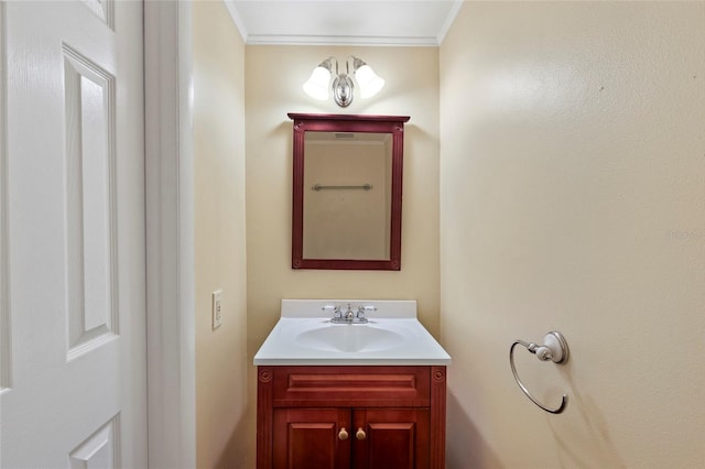 bathroom featuring a notable chandelier, vanity, and ornamental molding