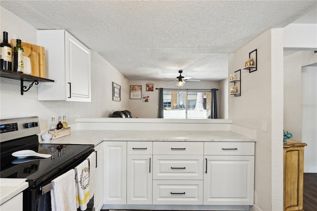 kitchen with white cabinetry, stainless steel electric range oven, ceiling fan, dark hardwood / wood-style floors, and a textured ceiling