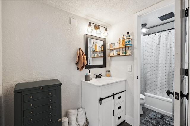 full bathroom with shower / tub combo, vanity, a textured ceiling, and toilet