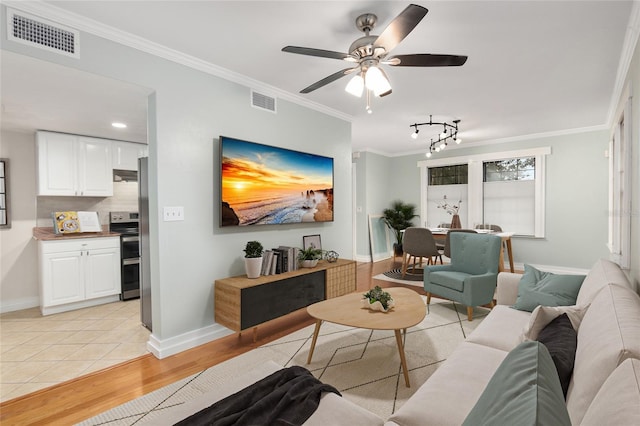 living room with ceiling fan, light tile patterned flooring, and crown molding