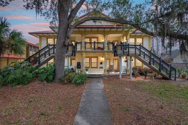 view of front of house featuring a patio area and a balcony