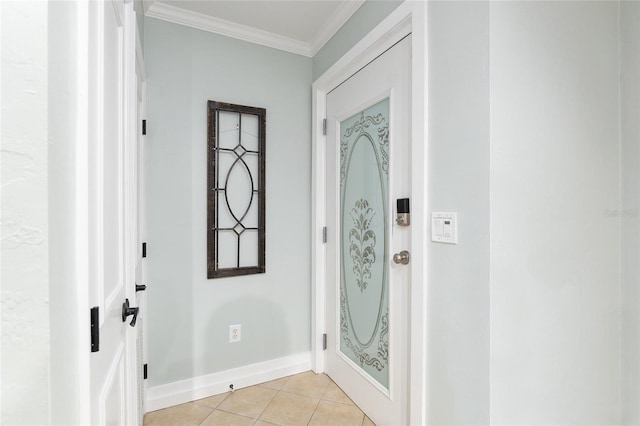 foyer entrance with light tile patterned floors and ornamental molding