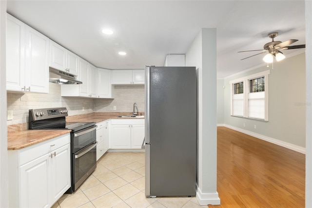 kitchen with ceiling fan, sink, light tile patterned flooring, stainless steel appliances, and white cabinets