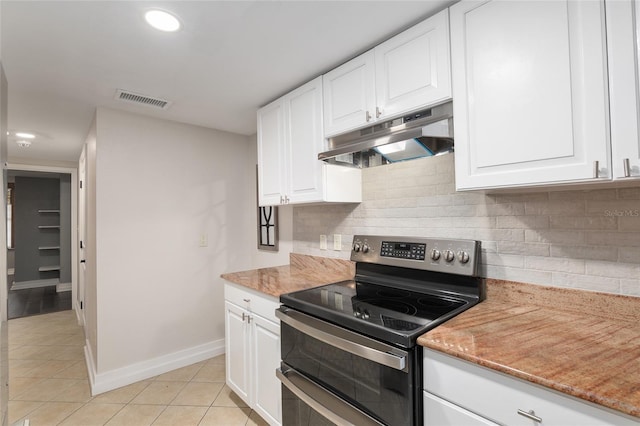 kitchen with backsplash, double oven range, white cabinetry, light tile patterned floors, and light stone counters