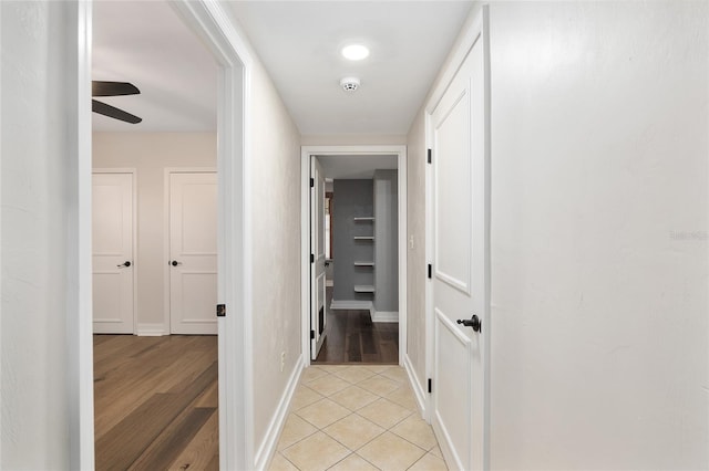 hall featuring light tile patterned flooring