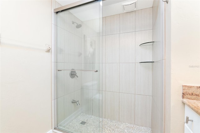 bathroom featuring vanity and an enclosed shower