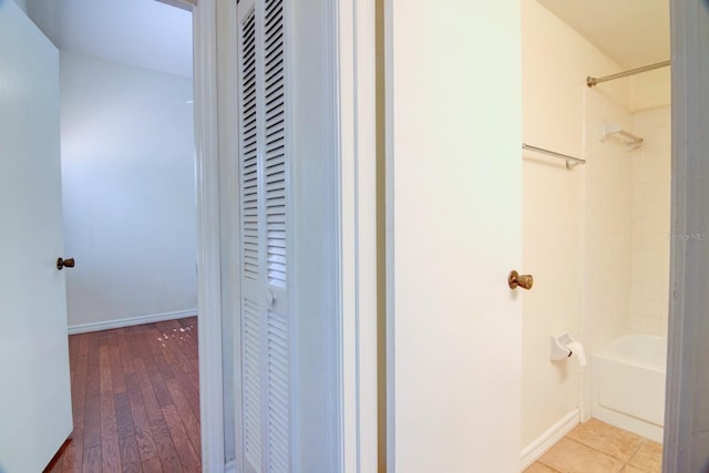 bathroom featuring hardwood / wood-style floors and shower / washtub combination