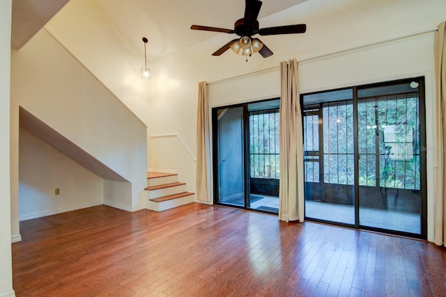 unfurnished living room with hardwood / wood-style flooring, ceiling fan, and lofted ceiling