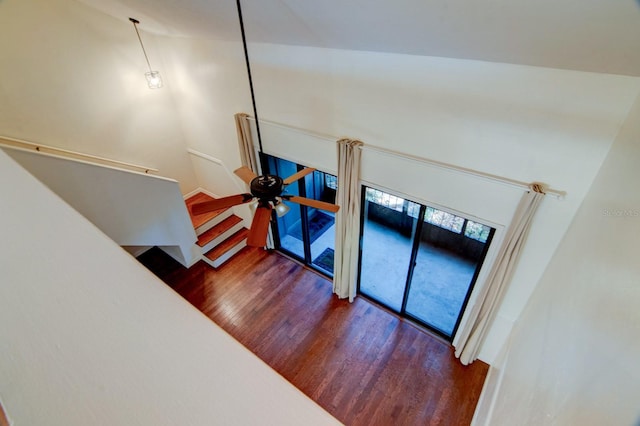 staircase with hardwood / wood-style floors and ceiling fan