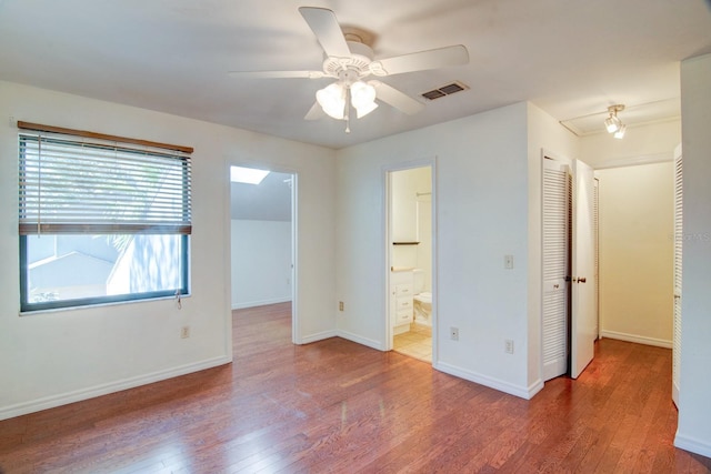 empty room with hardwood / wood-style flooring and ceiling fan