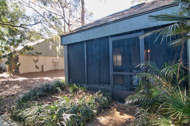 view of outdoor structure with a sunroom