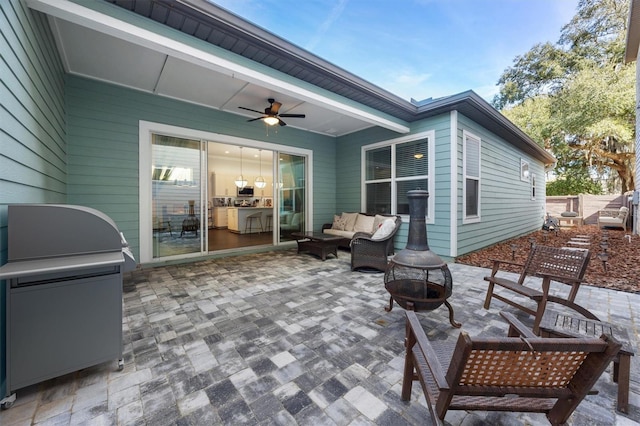 view of patio / terrace featuring an outdoor living space with a fire pit and ceiling fan