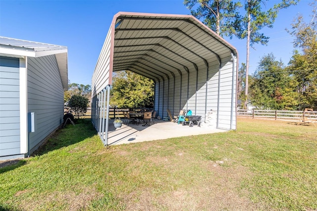 view of parking with a yard and a carport