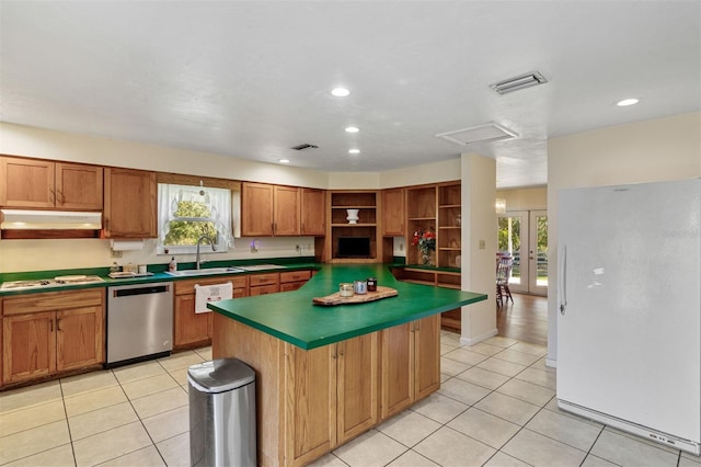 kitchen with a center island, light tile patterned floors, white appliances, and sink