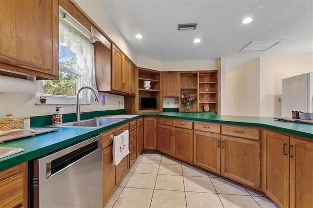 kitchen featuring light tile patterned floors, stainless steel dishwasher, and sink